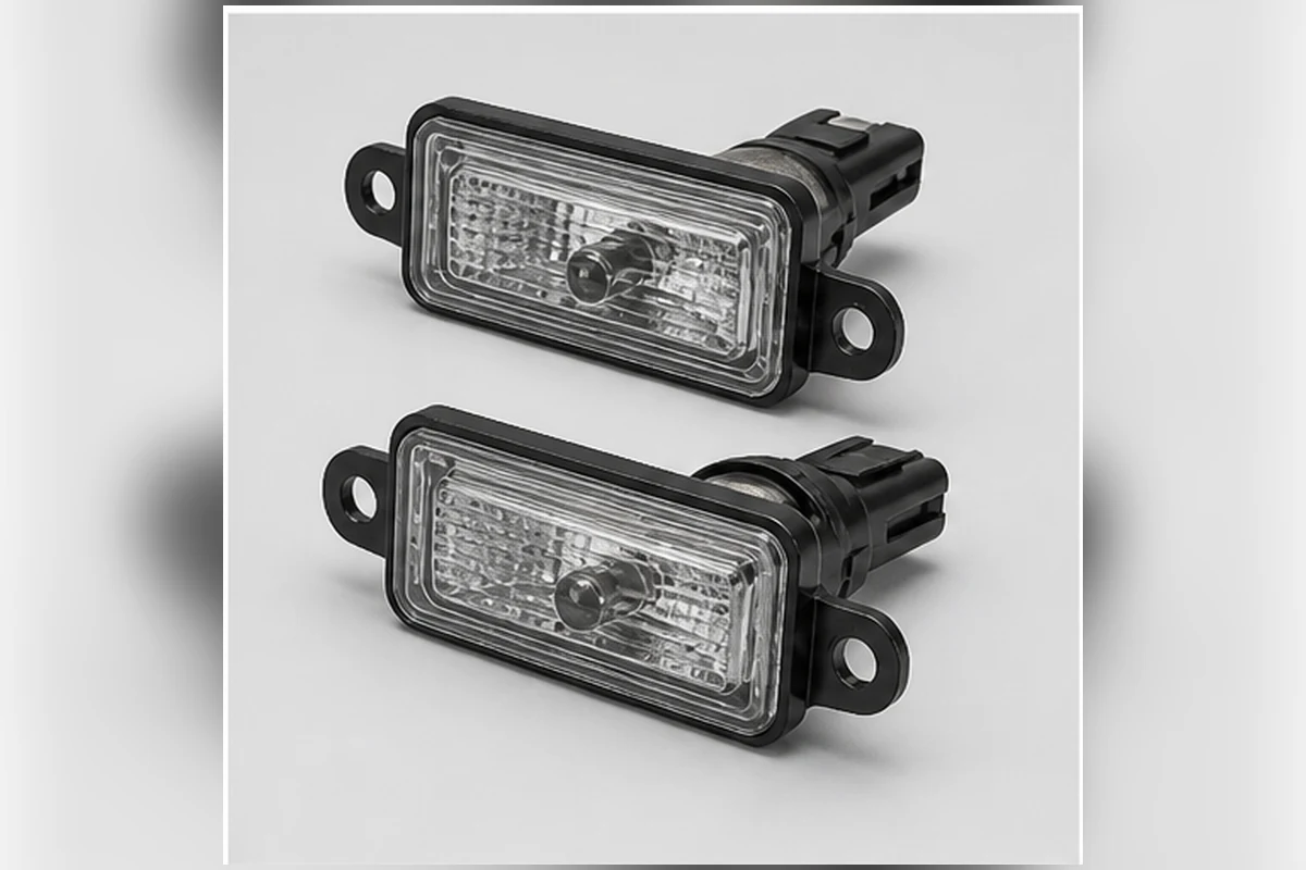 Pair of license-plate lamp housings with clear lenses, connectors and mounting tabs